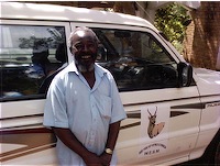 Photo of Singini Bandawe and one of his Pajeros